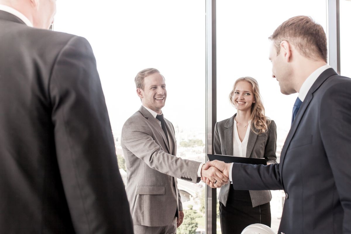 Happy business people shaking hands standing in modern office, nice to meet you, first impression, congrats, promoted to the post, reward accomplishments